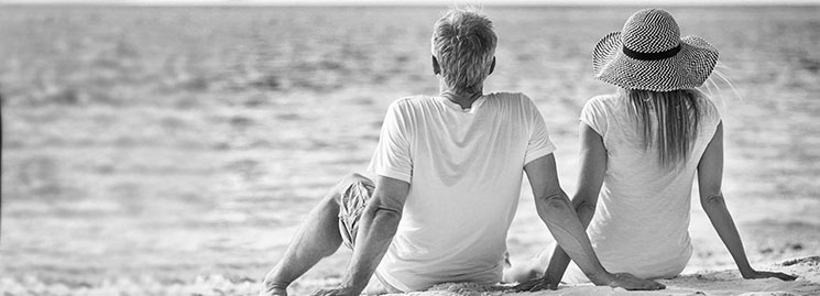 Mature couple sitting on the beach