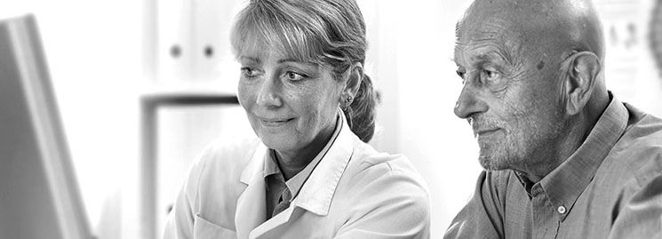 Audiologist talking with a patient about hearing aids