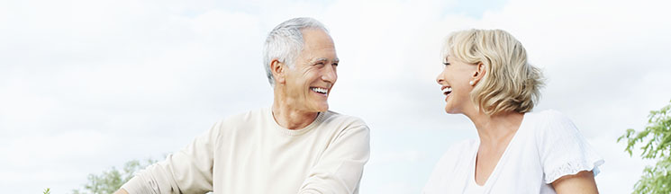 middle-aged couple riding bikes together