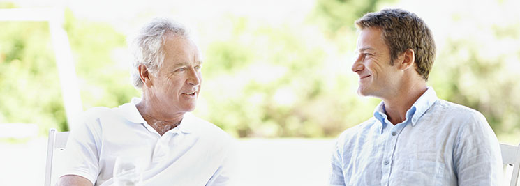 elderly father and adult son talking