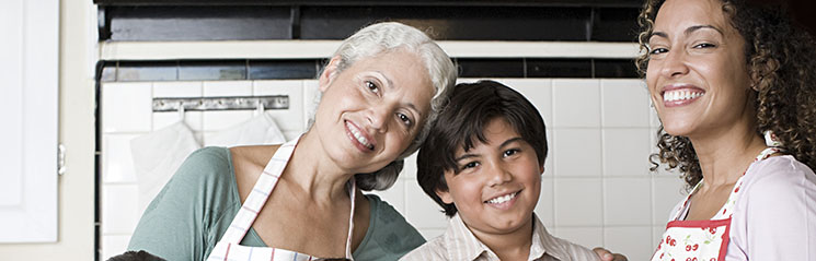 grandmother, daughter, and grandson baking in the kitchen together