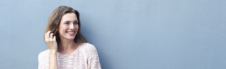 woman standing against a blue wall