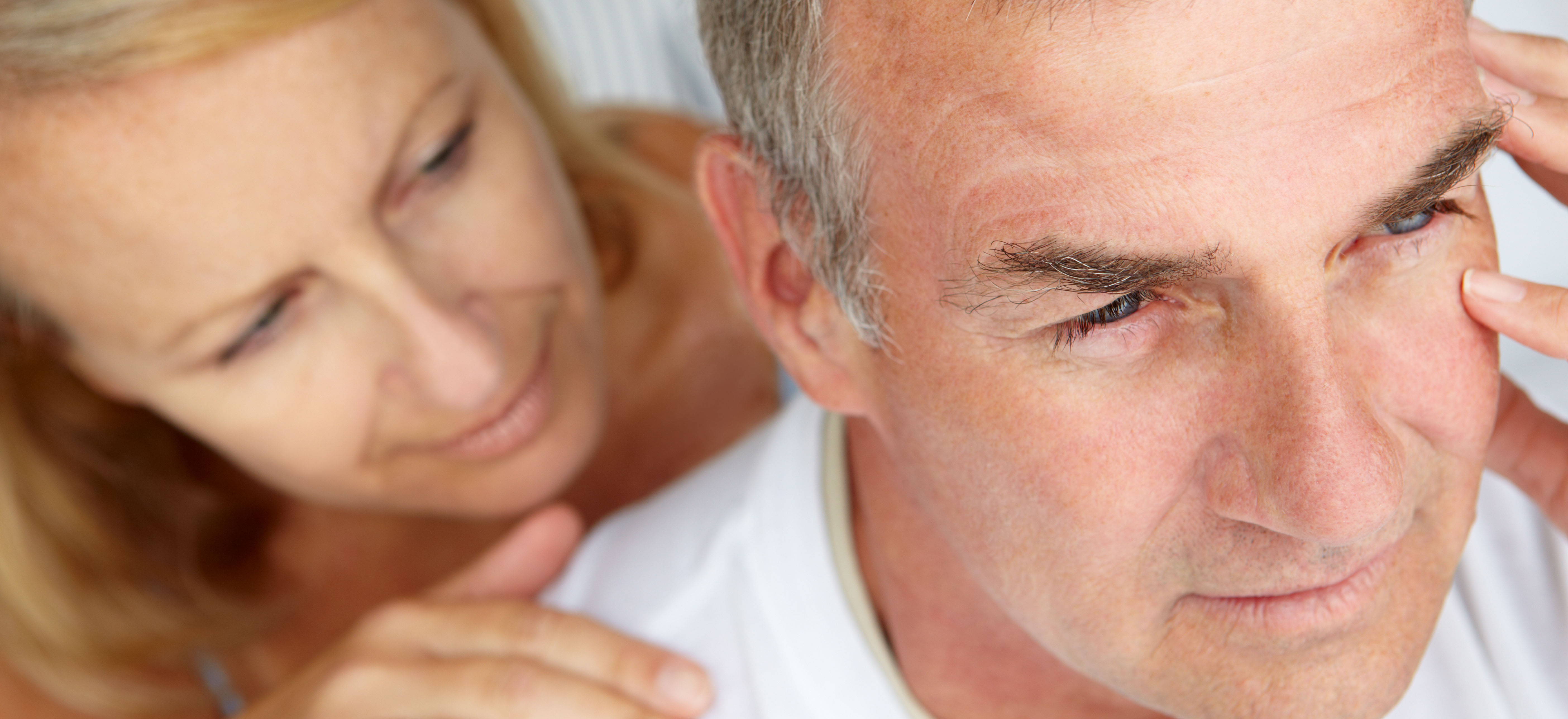middle-aged woman showing concern for her husband